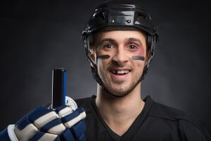 Funny hockey player smiling with one tooth missing. Isolated on